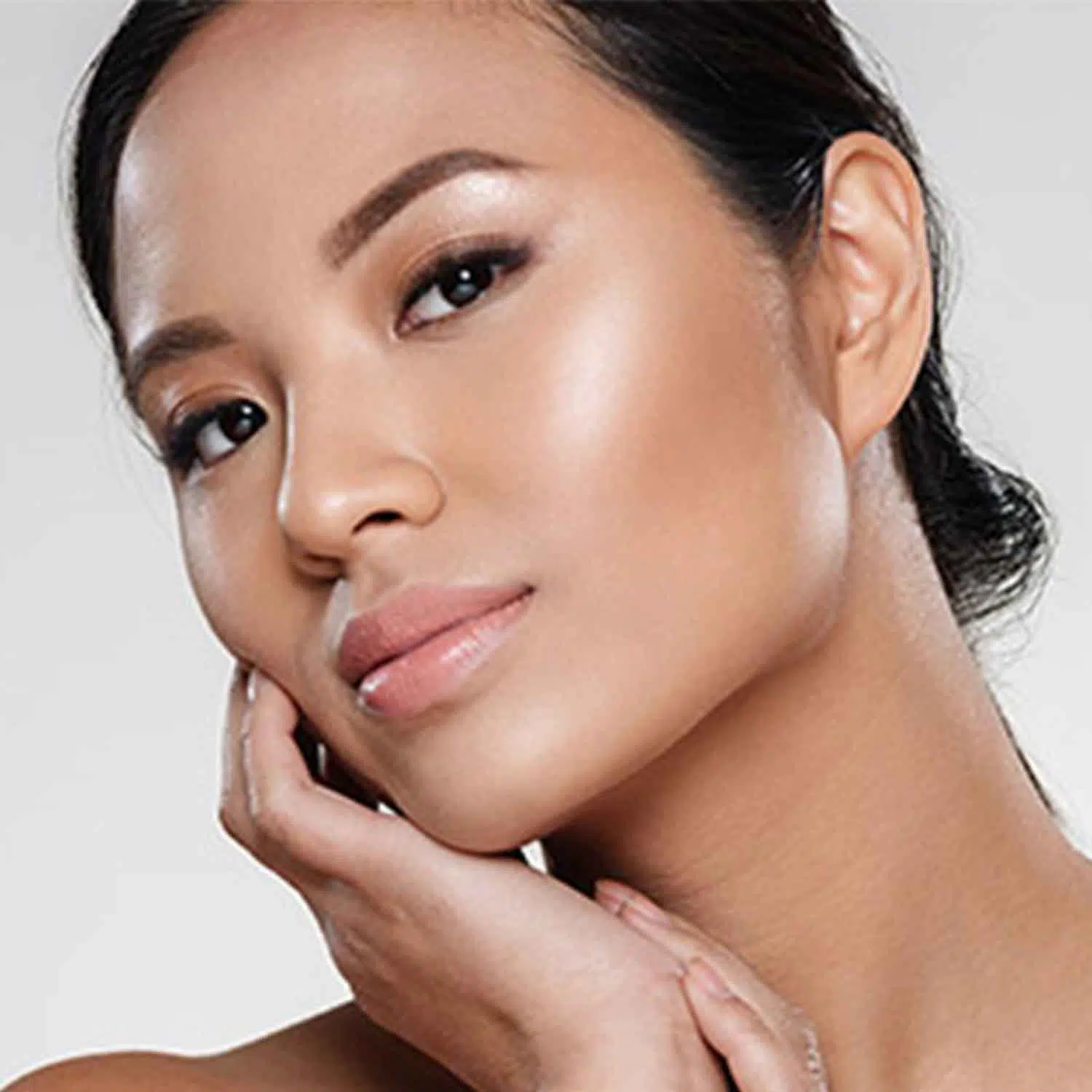 Woman with radiant skin revealing her most vibrant self through natural bio-aesthetic treatments