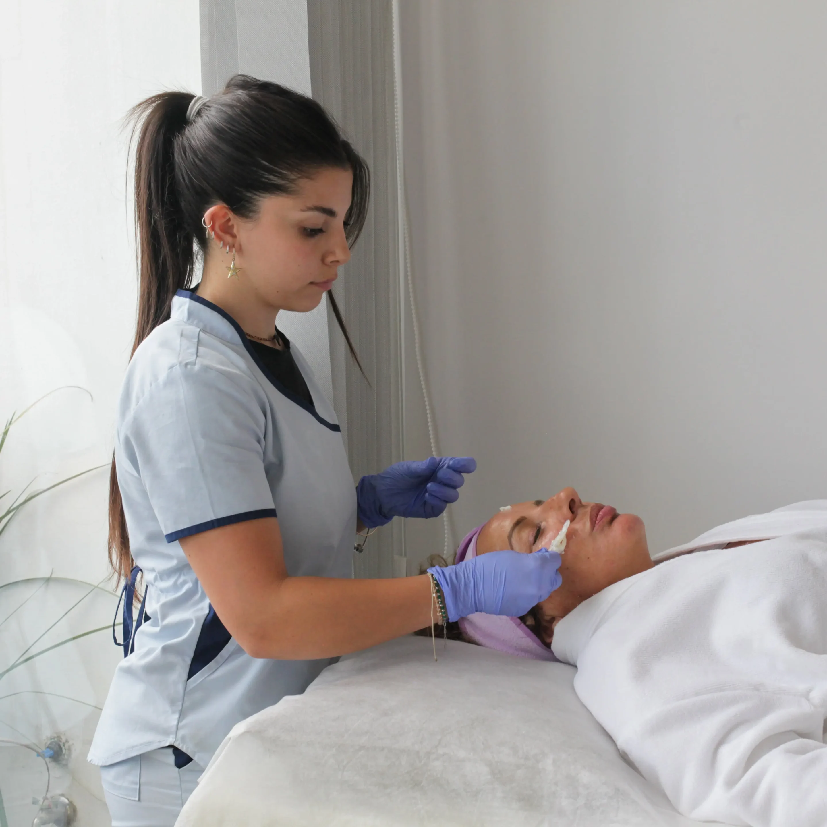 Esthetician performing a comprehensive facial analysis to start the patient's natural transformation journey at Memorial Care Esthetics